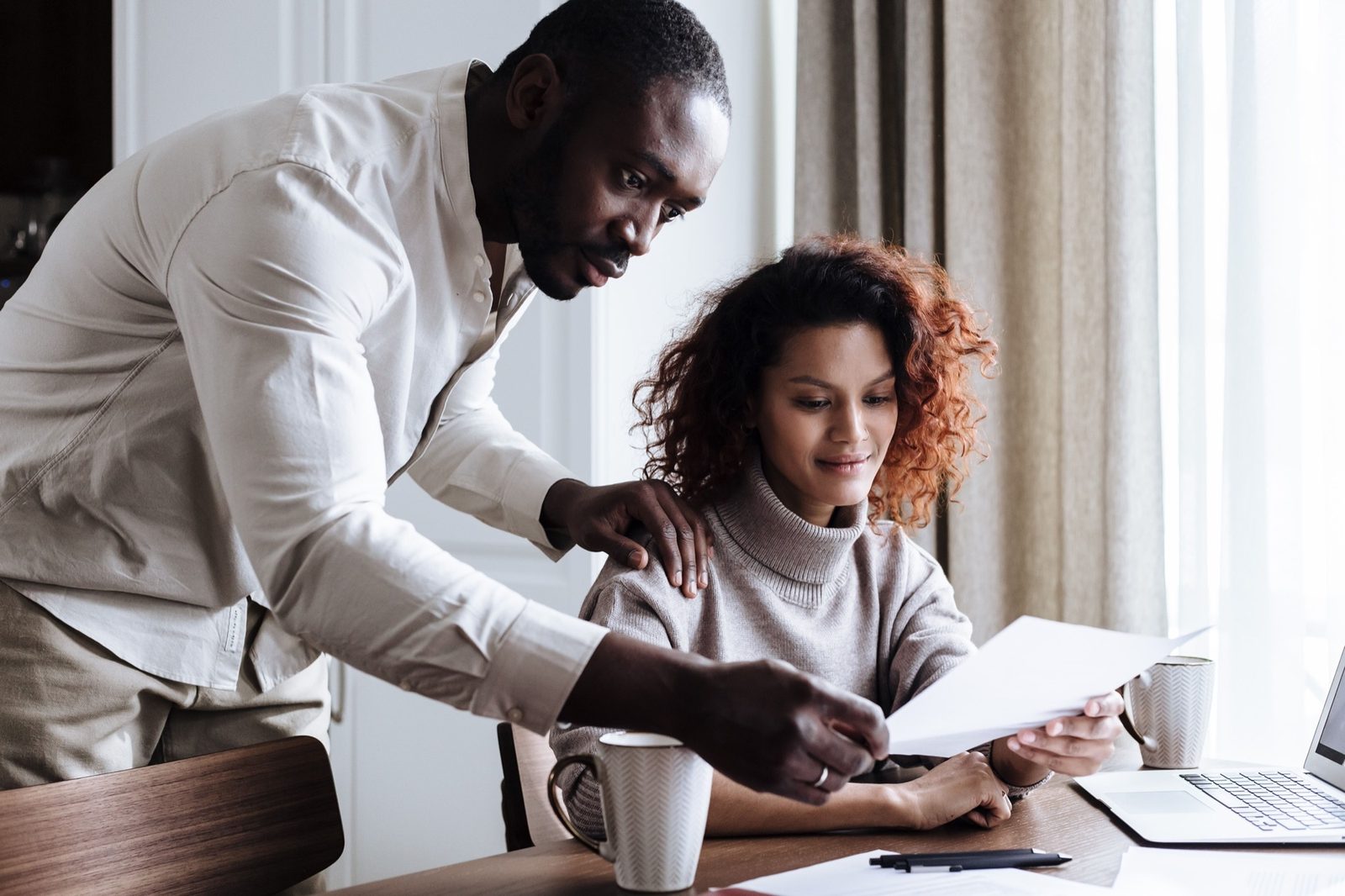 Couple reviewing paperwork together at home